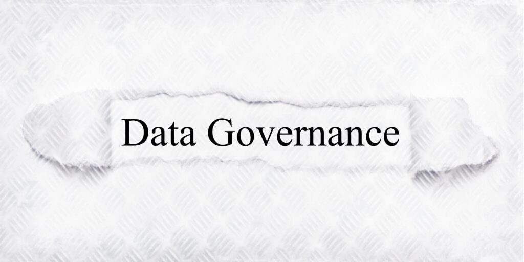 Metallic paper with a section torn out and the words "data governance."